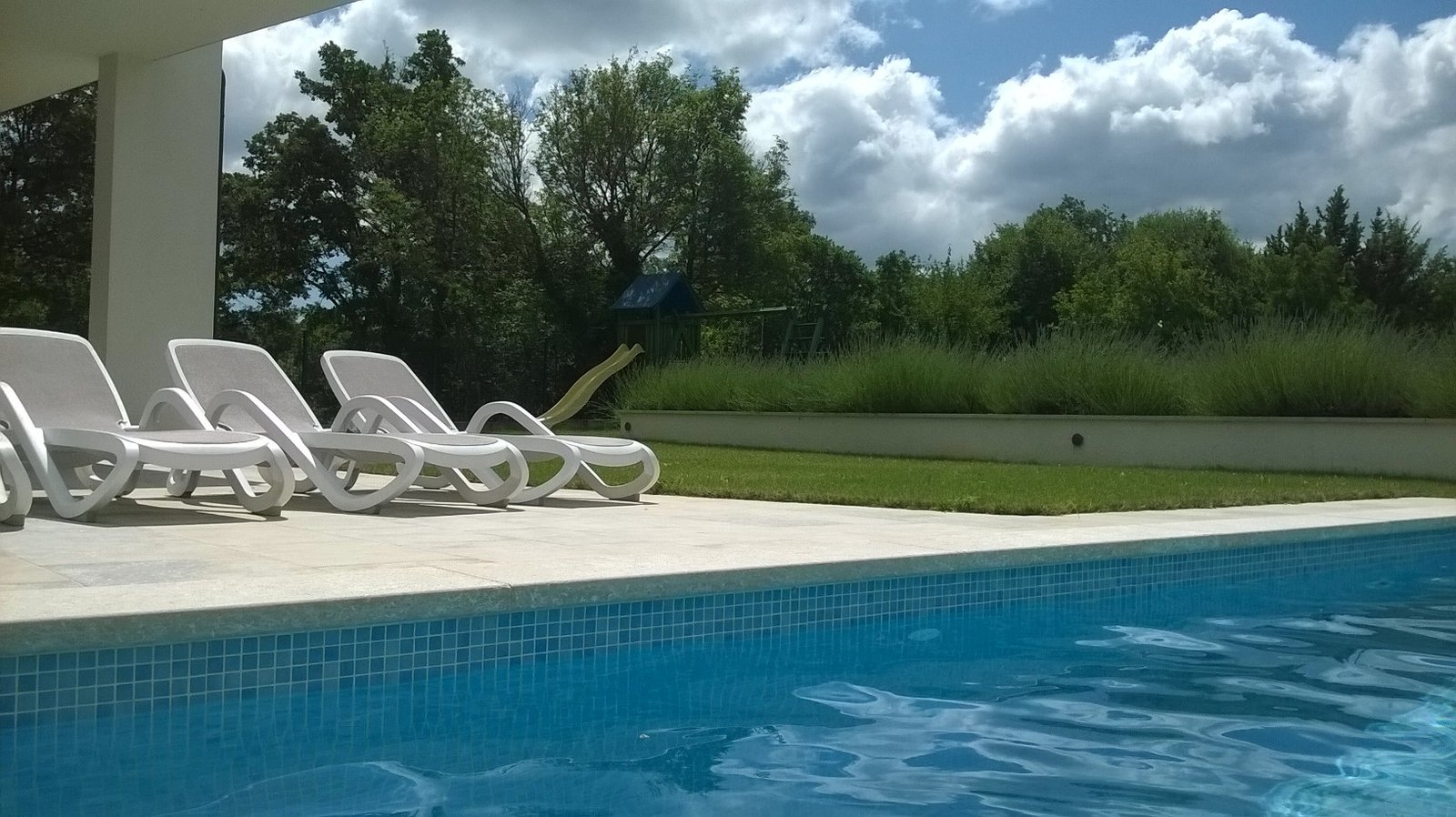 Villa Dora Istria Stokovci backyard terrace pool lounge chairs